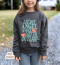Thumbnail for A young girl wearing a gray sweatshirt with a graphic design printed on it.