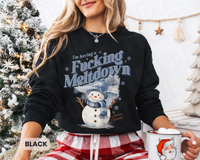 Thumbnail for A woman wearing a black sweatshirt with a snowman graphic and the text 