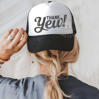 Thumbnail for A person wearing a black and white baseball cap with the text 