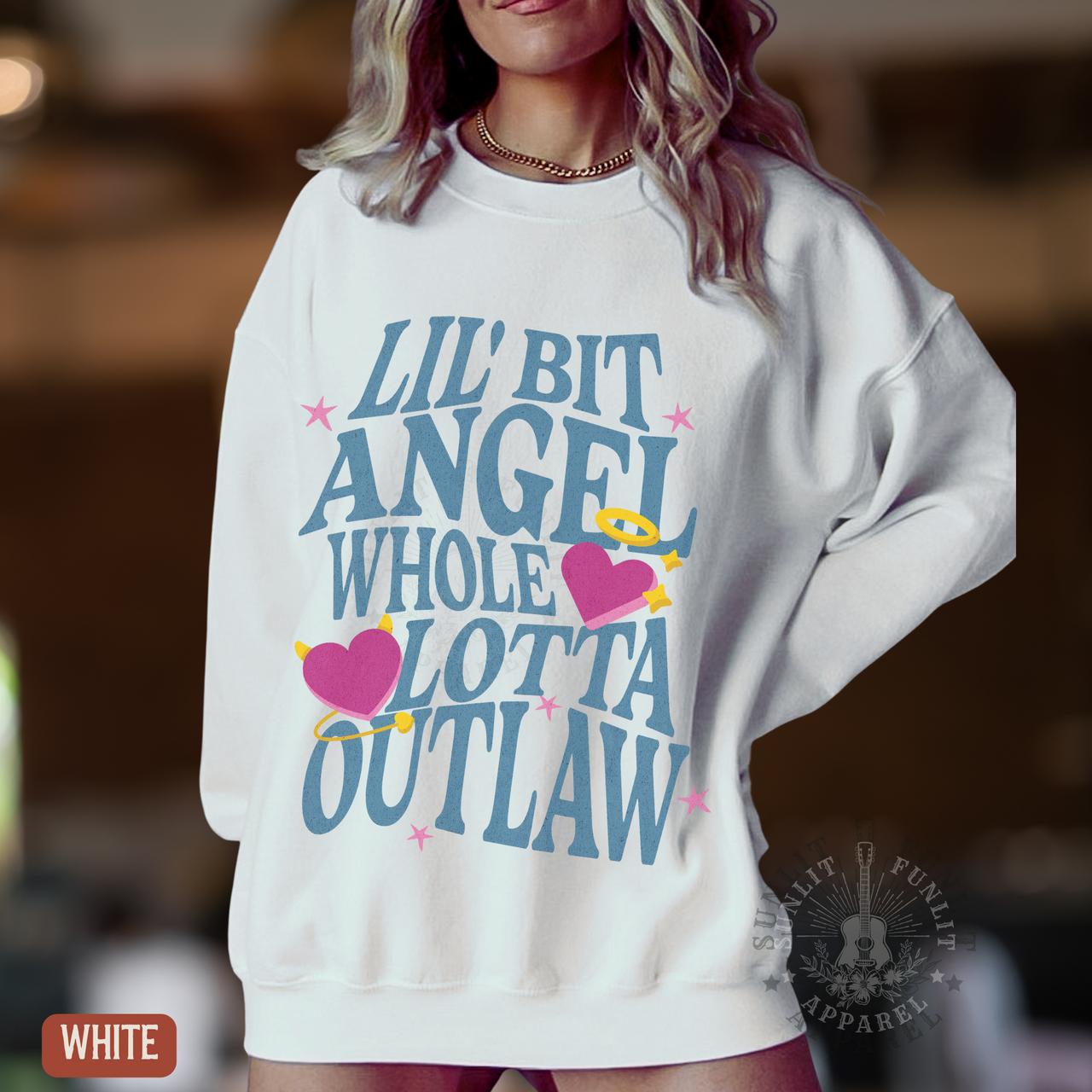 A woman wearing a white sweatshirt with a graphic design featuring text and heart-shaped icons.