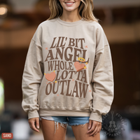 Thumbnail for A woman wearing a beige sweatshirt with a graphic design printed on it.