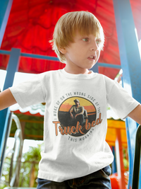 Thumbnail for A young boy wearing a white t-shirt with a graphic design on it, standing in front of a colorful background.