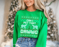 Thumbnail for A woman wearing a green sweater with a Christmas-themed design and text on it.