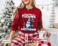 Thumbnail for A woman wearing a red sweater with a snowman graphic and the text 