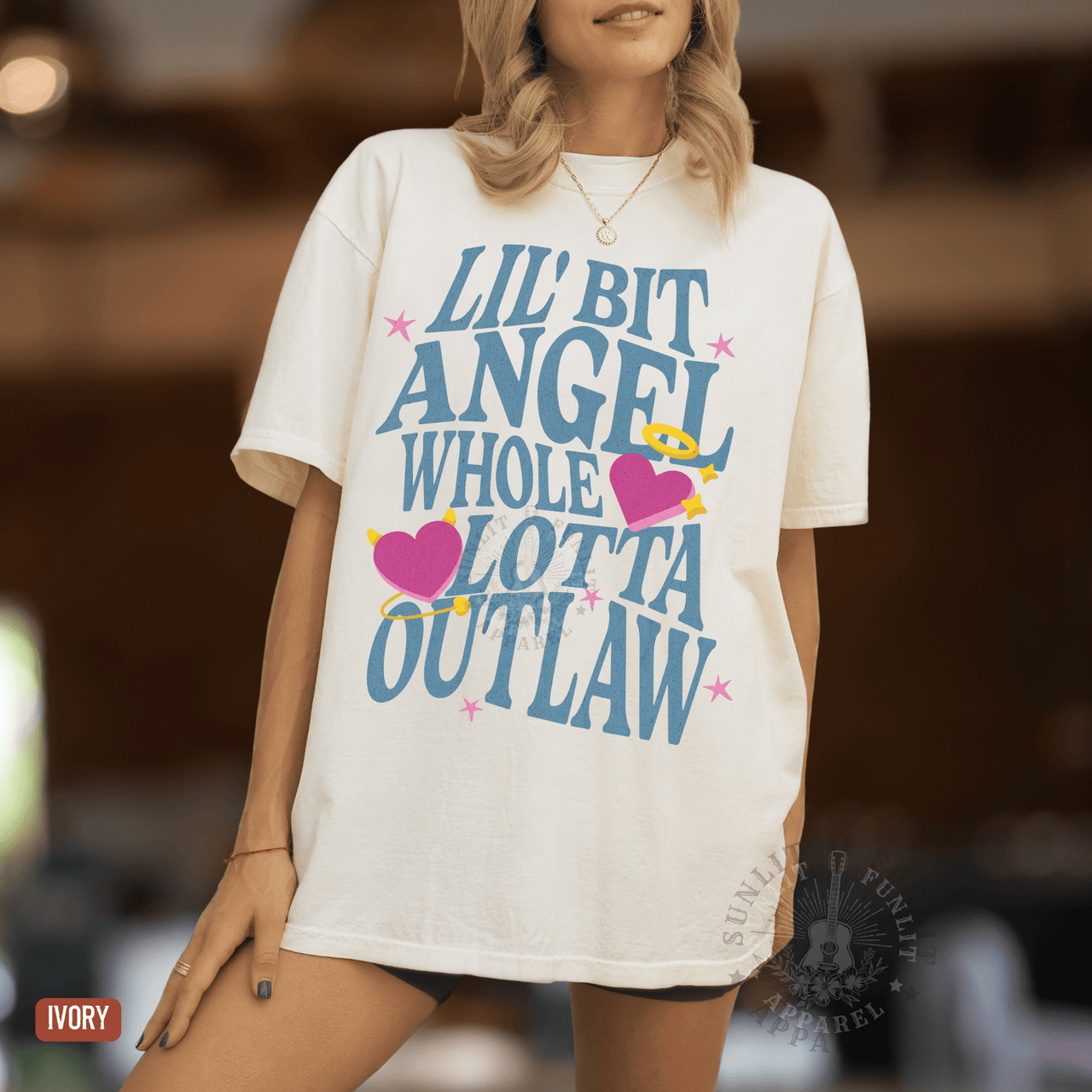 A woman wearing a white t-shirt with a graphic design featuring text and illustrations.