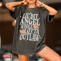 Thumbnail for A person wearing a black t-shirt with white text and graphics, posing with their hands on their head.