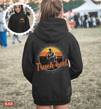 Thumbnail for A person wearing a black hoodie with a graphic design on the back, including a cowboy hat and the text 