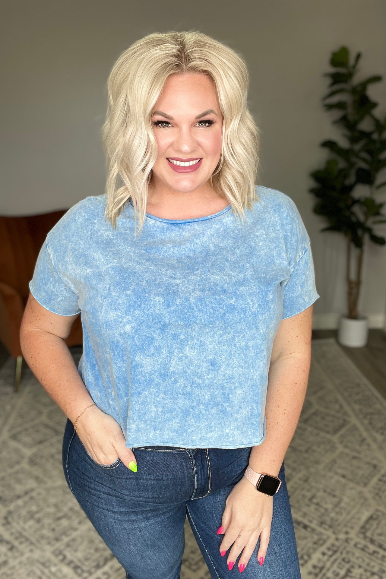 a woman standing in a room with her hands on her hips